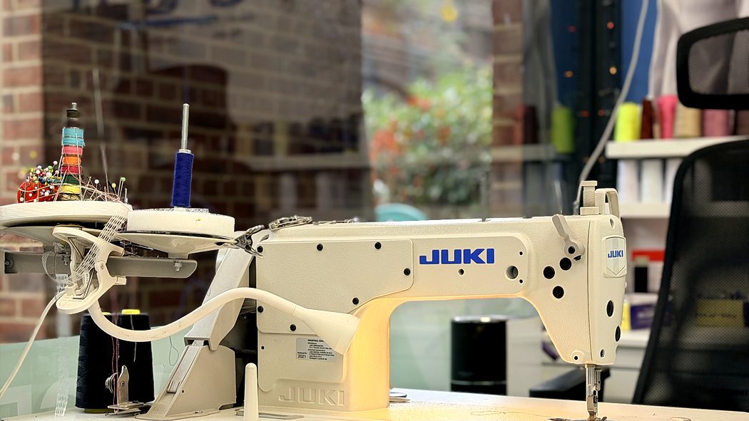 The JUKI industrial machine at our alterations bench, threaded and ready
