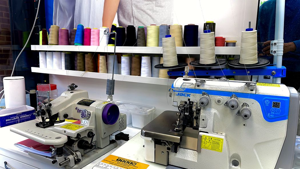 The thread rack above our overlockers, colours matched to each garment